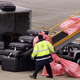 Airport workers remove luggage from an aircraft at London Heathrow Airport on May 18, 2006 in London, England